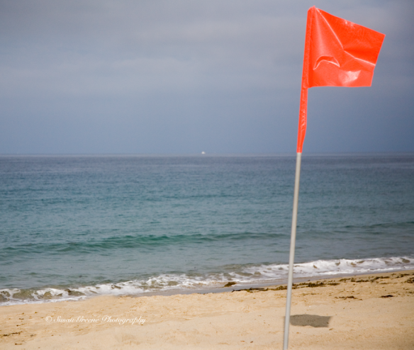 red orange flag on beach